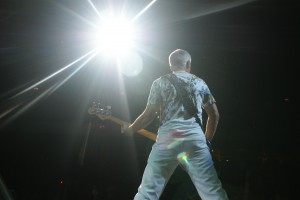 Adam Clayton playing bass